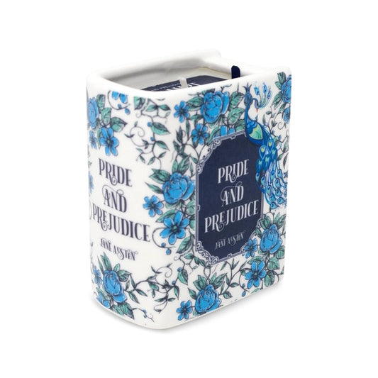 Floral-patterned book-shaped candle container with 'Pride and Prejudice' text on a white background