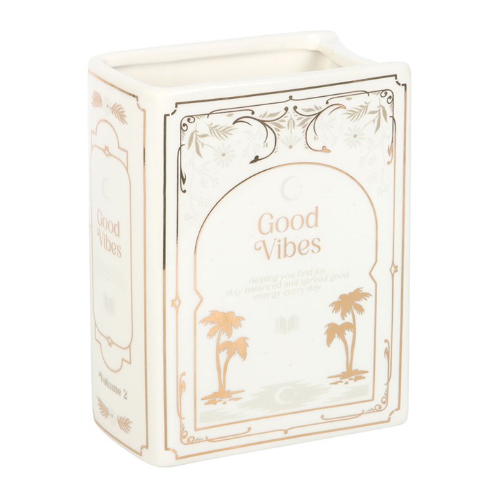 Decorative book shaped vase with 'Good Vibes' text and palm tree designs on a white background