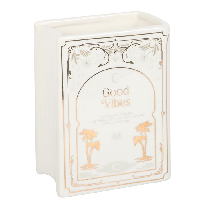 Decorative book shaped vase with 'Good Vibes' text and palm tree designs on a white background