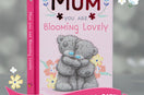 Pink book with wording: Mum you are blooming lovely and teddy bears on front with a grey and floral background