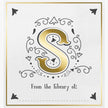 Decorative bookplate with a gold letter 'S' and black decorative elements on a white background.
