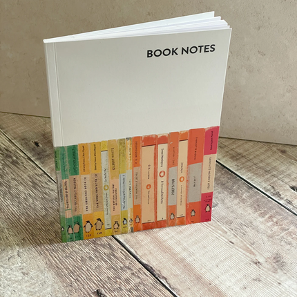 Notebook titled 'Book Notes' with a colorful design on a wooden surface