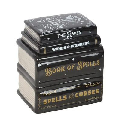 Stack of black books shaped burner with gold and white text on a white background