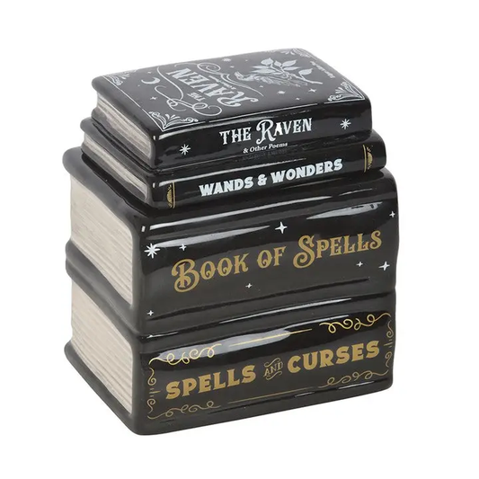 Stack of black books shaped burner with gold and white text on a white background
