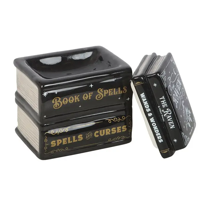 Black and gold decorative book-shaped container with 'Book of Spells' text on a white background