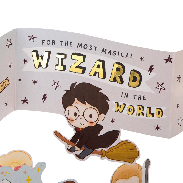 Cartoon character on a broomstick with text 'For the most magical wizard in the world' on a white background
