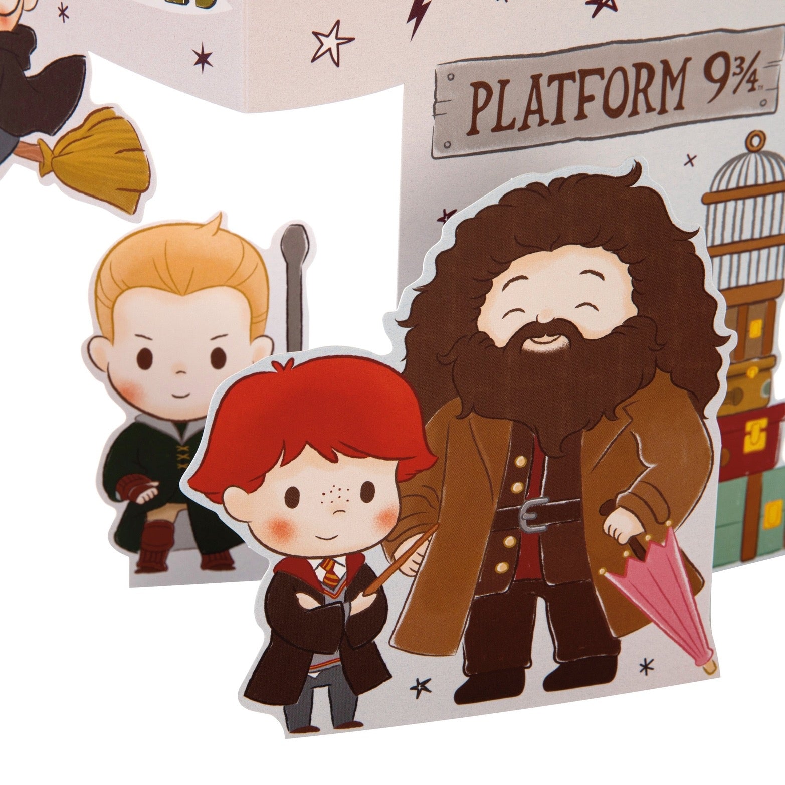 Cartoon-style cutouts of characters from a popular franchise, including a boy with red hair, a bearded man, and a sign for Platform 9 3/4.