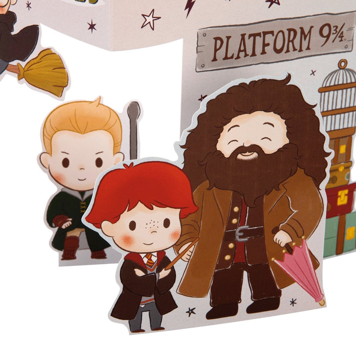 Cartoon-style cutouts of characters from a popular franchise, including a boy with red hair, a bearded man, and a sign for Platform 9 3/4.