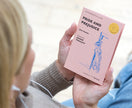 Person holding a pink book titled 'Pride and Prejudice' by Jane Austen.