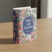 Floral design book-shaped container with 'Pride and Prejudice' text on a tabletop