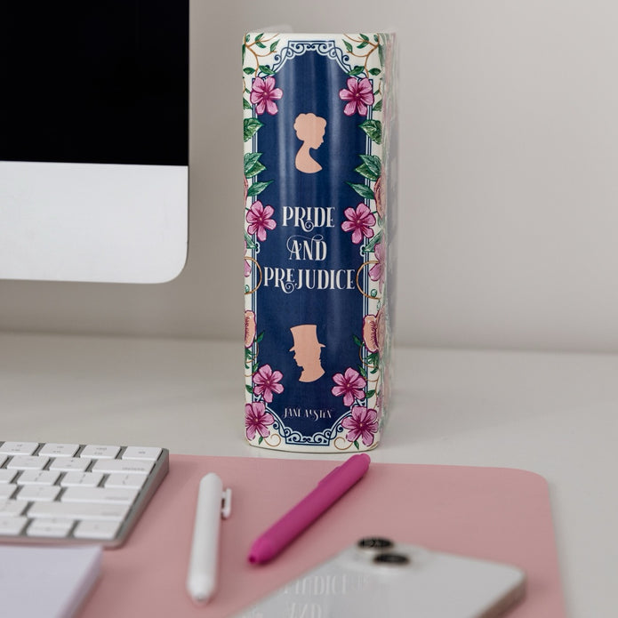 Book shaped vase with 'Pride and Prejudice' cover on a desk with computer and phone