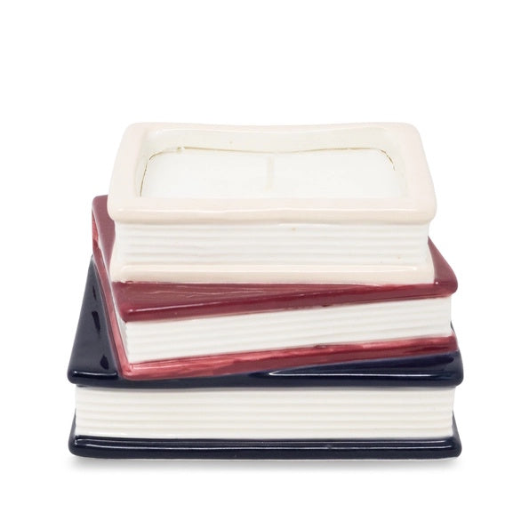 Stack of ceramic books with white, red, and blue covers on a white background
