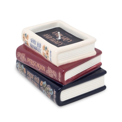 Stack of decorative books candle against a white background