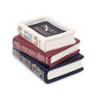 Stack of decorative books candle against a white background