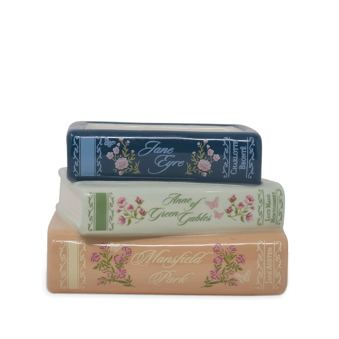Three decorative book-shaped items stacked vertically on a white background, featuring floral designs and titles including Jane Eyre, Anne of Green Gables, and Mansfield Park.