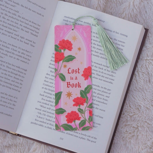 Floral bookmark titled 'Lost in a Book' on an open book with a tassel.