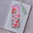 Floral bookmark titled 'Lost in a Book' on an open book with a tassel.