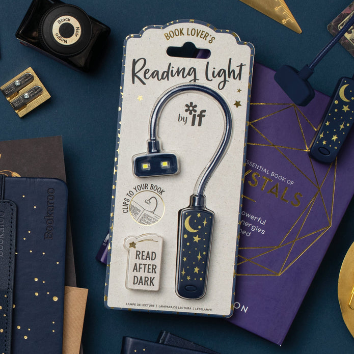 Reading light with packaging on a blue background with books and stationery items.