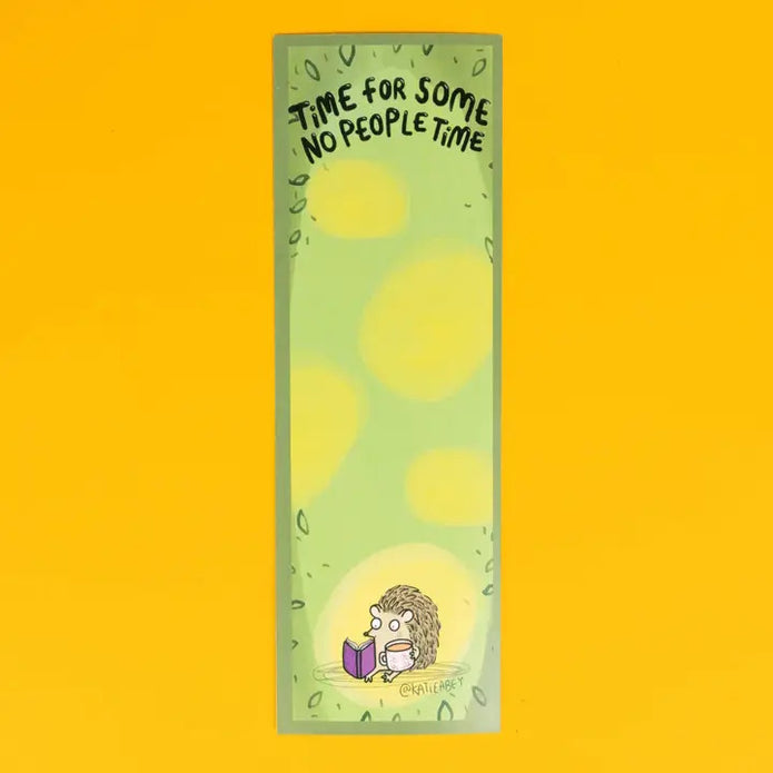 Bookmark with hedgehog reading a book and text 'Time for some no people time' on a yellow background