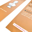 Close-up of a bookm with text and a character illustration on a white backgroundrk