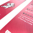Red and white bookmark with a character and text.