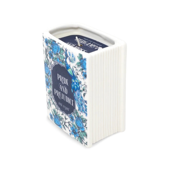 Book-shaped candle container with floral design and text on a white background