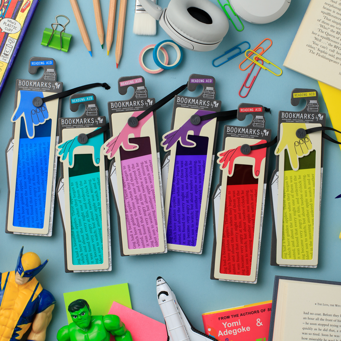 Five colourful bookmark sets with hand-shaped tabs in blue, teal, pink, purple, red, and yellow, displayed on a light blue desk with school and office props.