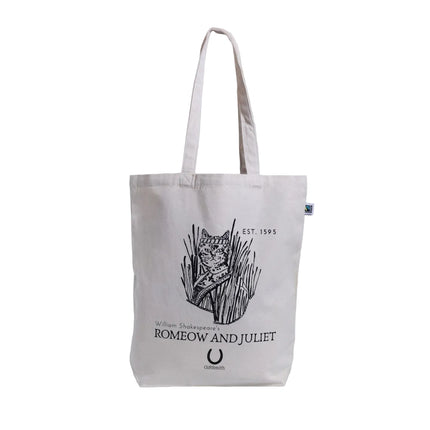 A beige cotton tote bag with black printed text and an illustration of a cat, referencing the theme from William Shakespeare's Romeo and Juliet.