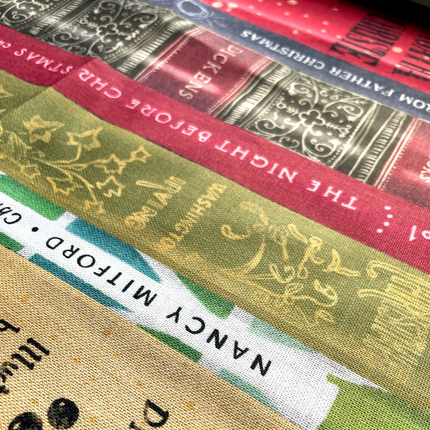 Close-up of book spines with decorative text and colors.