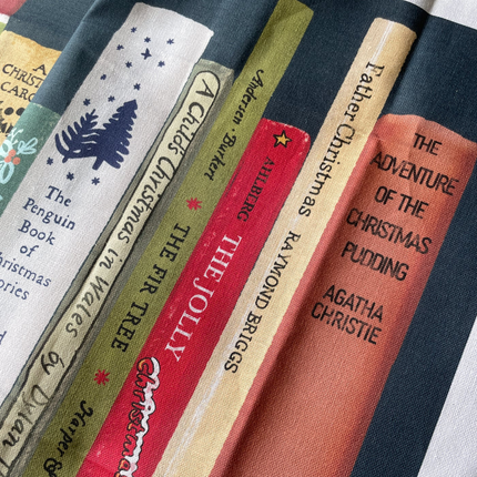 Collection of book spines with various titles and authors on a textured surface