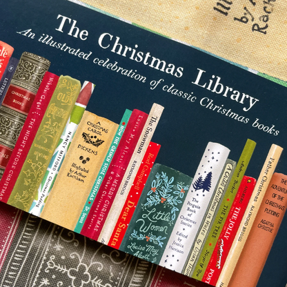 Book cover of 'The Christmas Library' with illustrated book spines on a textured background