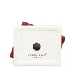 A square off-white ceramic candle holder bottom with a circular hole in the center, featuring the 'STEEL MILL and co.' brand name printed below.