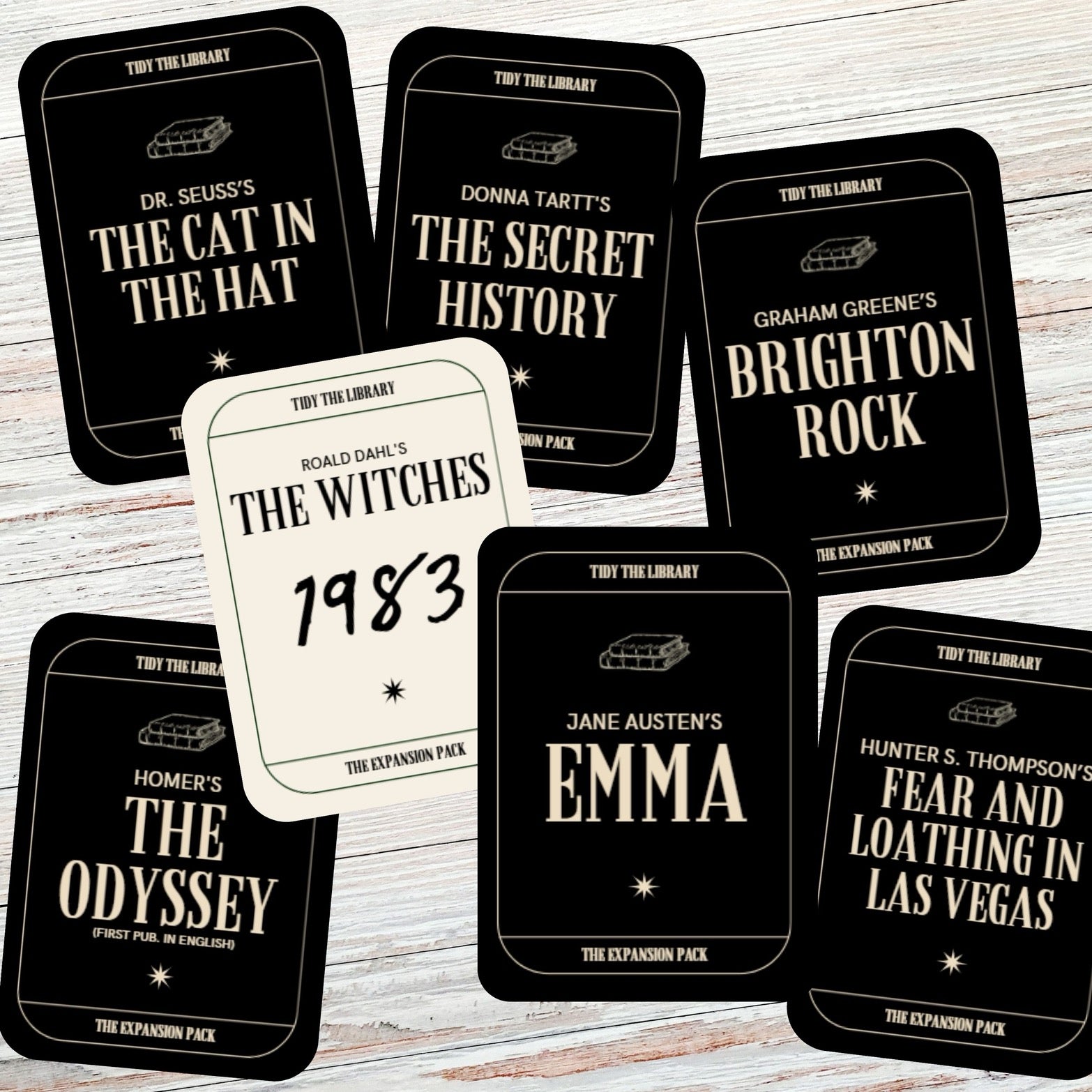 Collection of book-themed cards on a wooden surface