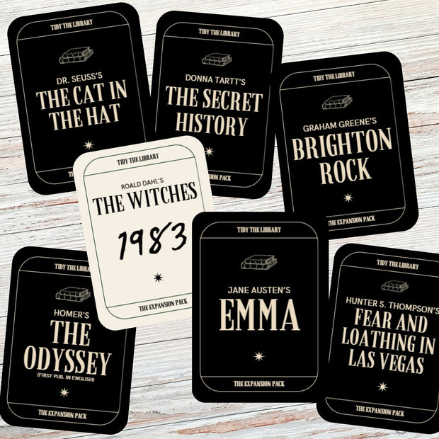 Collection of book-themed cards on a wooden surface
