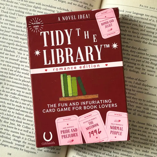 Card game box titled 'Tidy the Library' on top of a book