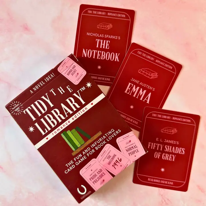 Card game packaging titled 'Tidy the Library' with book-themed cards on a pink background