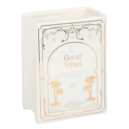 Decorative  book shaped vase with 'Good Vibes' text and palm tree designs on a white background