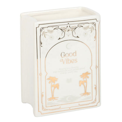 Decorative  book shaped vase with 'Good Vibes' text and palm tree designs on a white background