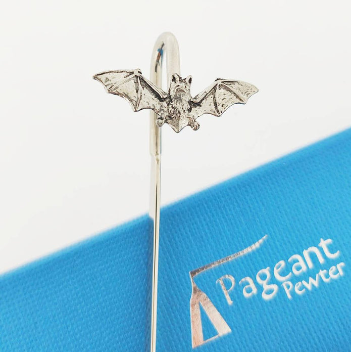 A silver bat-shaped pewter bookmark with spread wings, shown standing on a blue branded card that reads Pageant Pewter.