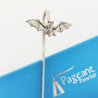 A silver bat-shaped pewter bookmark with spread wings, shown standing on a blue branded card that reads Pageant Pewter.