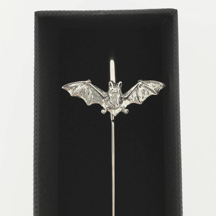 A silver bat-shaped bookmark with spread wings mounted on a straight pin, displayed inside a black presentation box against a white background.